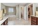 Bright bathroom featuring a soaking tub, tile floors, and double sink vanity at 358 Nature Brook Se Walk, Smyrna, GA 30082