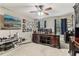 Spacious bedroom featuring a ceiling fan and complemented by a large wooden desk and entertainment center at 358 Nature Brook Se Walk, Smyrna, GA 30082