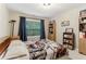 Bedroom with neutral walls, light carpet, window and built in bookshelf storage at 358 Nature Brook Se Walk, Smyrna, GA 30082