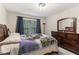 This bedroom has neutral walls, a window and a large dresser with attached mirror at 358 Nature Brook Se Walk, Smyrna, GA 30082