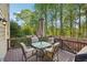Relaxing deck with outdoor furniture and potted plants, surrounded by lush trees at 358 Nature Brook Se Walk, Smyrna, GA 30082