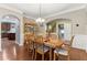 Elegant dining area with hardwood floors and open access to kitchen, featuring an adjacent staircase at 358 Nature Brook Se Walk, Smyrna, GA 30082