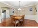 Spacious dining room showcasing hardwood floors, decorative molding, and featuring an archway entrance to adjacent rooms at 358 Nature Brook Se Walk, Smyrna, GA 30082