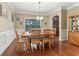 Inviting dining room featuring hardwood floors, decorative molding, with natural light streaming through the windows at 358 Nature Brook Se Walk, Smyrna, GA 30082