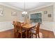 Traditional dining room boasting hardwood floors, a wooden table with chairs, and natural light through a window at 358 Nature Brook Se Walk, Smyrna, GA 30082