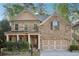 Charming two-story brick home featuring a welcoming front porch and a well-manicured front yard with beautiful landscaping at 358 Nature Brook Se Walk, Smyrna, GA 30082