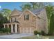 Charming two-story brick home featuring a welcoming front porch, a well-manicured yard, and a two car garage at 358 Nature Brook Se Walk, Smyrna, GA 30082