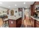 Gourmet kitchen with a granite island, stainless steel appliances, dark wood cabinetry, with open access to living areas at 358 Nature Brook Se Walk, Smyrna, GA 30082
