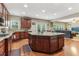 Open-concept kitchen with granite countertops, stainless steel appliances, dark cabinets, and seamless flow to living area at 358 Nature Brook Se Walk, Smyrna, GA 30082