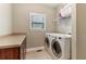 Charming laundry room complete with washer, dryer, storage shelf, and a window for natural light at 358 Nature Brook Se Walk, Smyrna, GA 30082