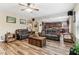 Elegant living room with hardwood floors, a fireplace, and an open view into the modern kitchen at 358 Nature Brook Se Walk, Smyrna, GA 30082