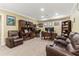 Relaxing living room with carpeted flooring, leather armchairs, and a desk with built-in shelving at 358 Nature Brook Se Walk, Smyrna, GA 30082
