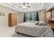 A well-lit primary bedroom features a beautiful tray ceiling, a large bed, and ample closet space at 358 Nature Brook Se Walk, Smyrna, GA 30082