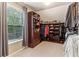Walk-in closet with a window, custom shelving, and carpeted floor at 358 Nature Brook Se Walk, Smyrna, GA 30082