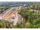 Expansive aerial view highlighting a community's layout, with homes bordering lush wooded areas at 461 Maypop Ln, Woodstock, GA 30188