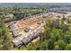 Wide aerial shot displaying a new residential development nestled amongst a dense green forest at 461 Maypop Ln, Woodstock, GA 30188