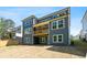 The rear of this home features a multi-story deck and a spacious yard at 461 Maypop Ln, Woodstock, GA 30188