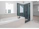 Modern bathroom with a soaking tub and glass-enclosed shower at 461 Maypop Ln, Woodstock, GA 30188