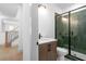 Modern bathroom showcases a sleek vanity, a glass-enclosed shower with unique green tile at 461 Maypop Ln, Woodstock, GA 30188