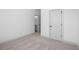 This bedroom features neutral carpeting, white walls, and a door leading to a bathroom at 461 Maypop Ln, Woodstock, GA 30188