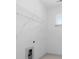 This closet offers built-in shelving, white walls and trim, and a bright window at 461 Maypop Ln, Woodstock, GA 30188