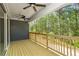 Spacious deck with wood railing offers serene views of the surrounding lush greenery and ceiling fans at 461 Maypop Ln, Woodstock, GA 30188