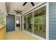 Covered deck features ceiling fans and large sliding glass doors to the interior at 461 Maypop Ln, Woodstock, GA 30188