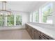Bright dining area features natural light, modern light fixture and plenty of storage space with countertop at 461 Maypop Ln, Woodstock, GA 30188