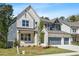 Beautiful two-story home with a well-manicured lawn and a two-car garage at 461 Maypop Ln, Woodstock, GA 30188