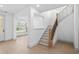 Inviting foyer with hardwood floors, staircase, and abundant natural light at 461 Maypop Ln, Woodstock, GA 30188