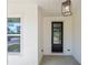 Charming front porch with brick columns and a modern pendant light fixture at 461 Maypop Ln, Woodstock, GA 30188
