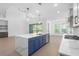 Bright, open kitchen featuring an island, modern appliances, and views to the outdoor space at 461 Maypop Ln, Woodstock, GA 30188