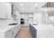 Well-equipped kitchen with stainless steel appliances, quartz countertops, and a large island at 461 Maypop Ln, Woodstock, GA 30188