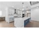 Stylish kitchen with island, pendant lighting, stainless steel appliances, and lots of counterspace at 461 Maypop Ln, Woodstock, GA 30188