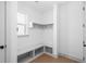 Mudroom boasts built-in bench with cubbies, shelving, and hooks, perfect for organization at 461 Maypop Ln, Woodstock, GA 30188