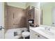 Bathroom with a shower and a soaking tub combo, white and brown tile, and a neutral green wall at 2069 Willow Chase Ct, Tucker, GA 30084