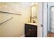 Half bathroom with black vanity, framed mirror, and floral artwork at 2069 Willow Chase Ct, Tucker, GA 30084