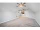 Bright bonus room featuring neutral carpeting, ceiling fans, and fresh paint at 2069 Willow Chase Ct, Tucker, GA 30084