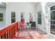 A cozy deck with a patterned rug, outdoor seating, and views of the house and surrounding trees at 2069 Willow Chase Ct, Tucker, GA 30084