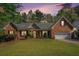 Charming brick home with a well-manicured lawn, a covered entrance, and an attached two car garage at 2069 Willow Chase Ct, Tucker, GA 30084