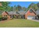Charming brick home with a well-manicured lawn, a covered entrance, and an attached two car garage at 2069 Willow Chase Ct, Tucker, GA 30084