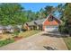 A charming brick home with a well-manicured lawn, an attached garage, and a long drive way at 2069 Willow Chase Ct, Tucker, GA 30084