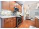 Traditional kitchen with wooden cabinets, stainless steel appliances, and stylish backsplash at 2069 Willow Chase Ct, Tucker, GA 30084