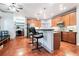 Kitchen with wood floors and cabinets, stainless appliances, with barstool seating and desk area at 2069 Willow Chase Ct, Tucker, GA 30084