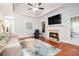Cozy living room featuring a fireplace, tray ceiling, and hardwood floors at 2069 Willow Chase Ct, Tucker, GA 30084
