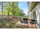 Spacious backyard featuring a patio with outdoor seating and a grill, surrounded by lush greenery at 3377 Park Pointe Cir, Scottdale, GA 30079