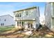 View of the back of the home with a patio, grill, seating and green space at 3377 Park Pointe Cir, Scottdale, GA 30079