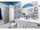 Bathroom features a tub, a white vanity, and blue whale wallpaper at 3377 Park Pointe Cir, Scottdale, GA 30079