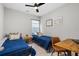 Bedroom features two twin beds, a ceiling fan, neutral walls, and a desk area at 3377 Park Pointe Cir, Scottdale, GA 30079