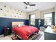 Fun bedroom with playful wall decor, large windows, ceiling fan, and gray carpeting at 3377 Park Pointe Cir, Scottdale, GA 30079
